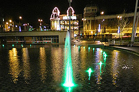 Green fountain lights in the mirror pool. Odeon and Alhambra theatre in the background